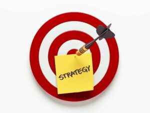 Image of target with dart pinning note that reads, "Strategy"