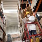 warehouse worker wearing a face mask and social distancing