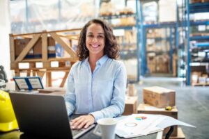 woman using laptop in a warehouse