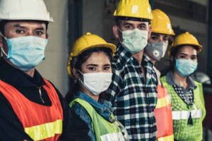 Diverse group of warehouse workers in masks