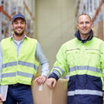Two men standing in warehouse