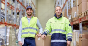 Two men standing in warehouse