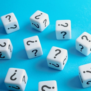 Image of scattered dice with question marks